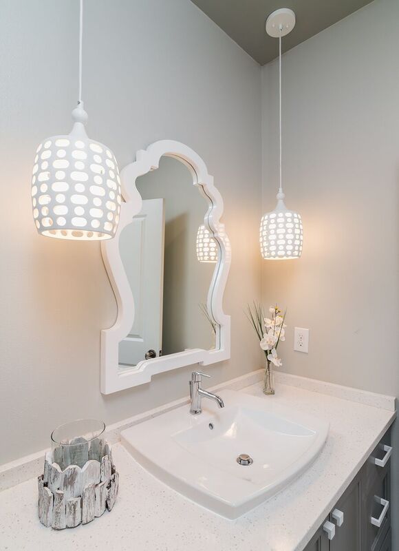 Neutral colored budget bath with white pendant light fixtures