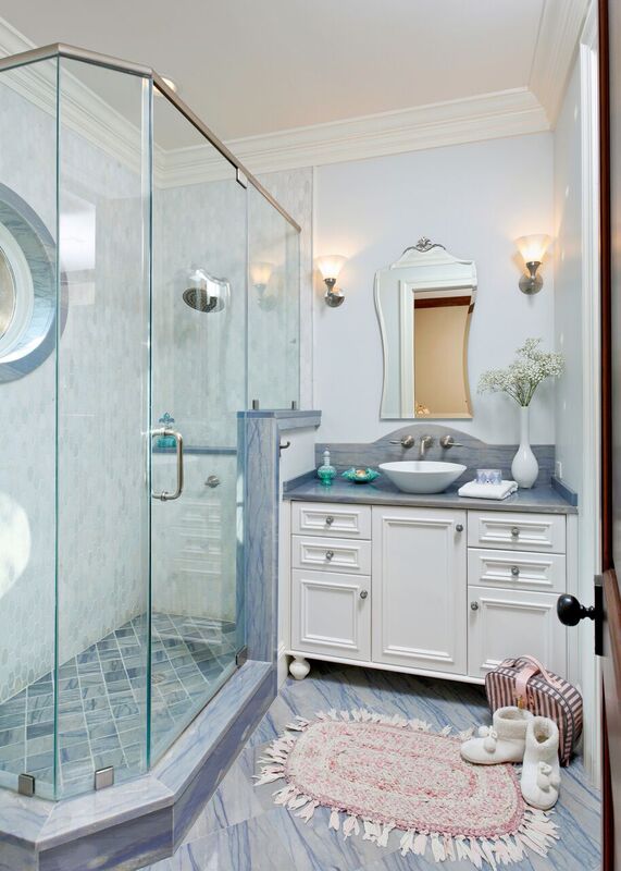 Blue and white bathroom with glass shower with window