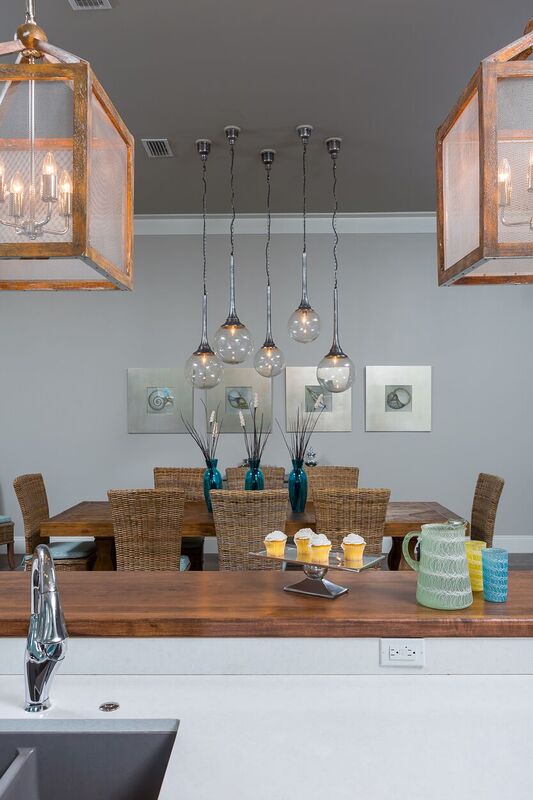 coastal new construction dining area and eat-at bar with pendant lighting