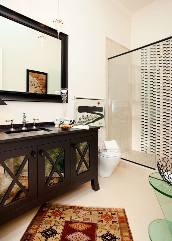 Bathroom with dark vanity with large mirror and glass shower, Pensacola Florida Bath Remodel