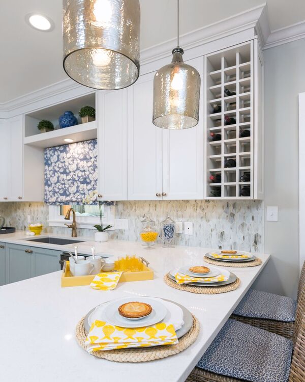 blue, white and yellow kitchen remodel - blue and white cabinets with white counter tops and silver pendants