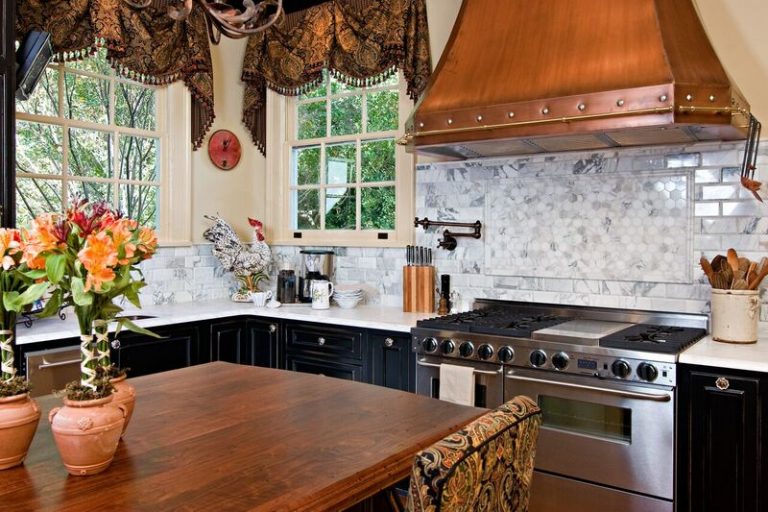 Historic Home in Old Mobile: Calcutta gold marble, dark cabinets, custom copper hood, 48 inch range, island with distressed walnut top