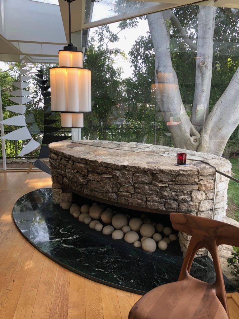 stone fireplace encased in glass wall stone fireplace encased in glass wall