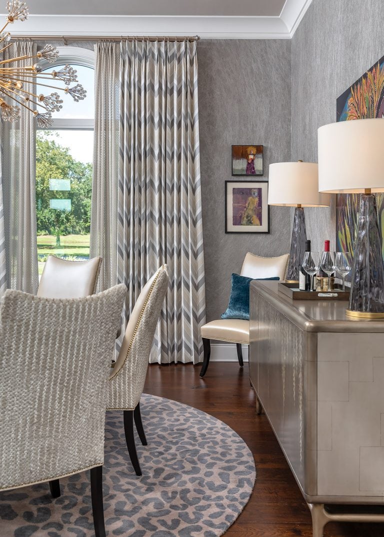 grey dining room with dining chairs and grey wallpaper