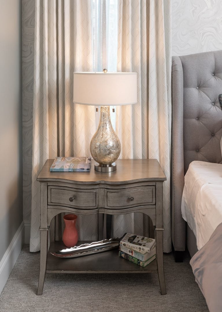 nightstand with lamp and curtains, feminine bedroom