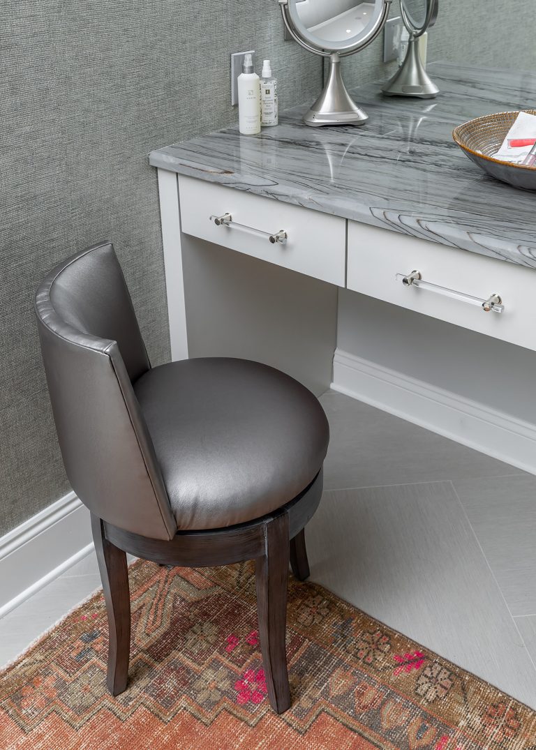 Vanity with grey chair and vintage rug
