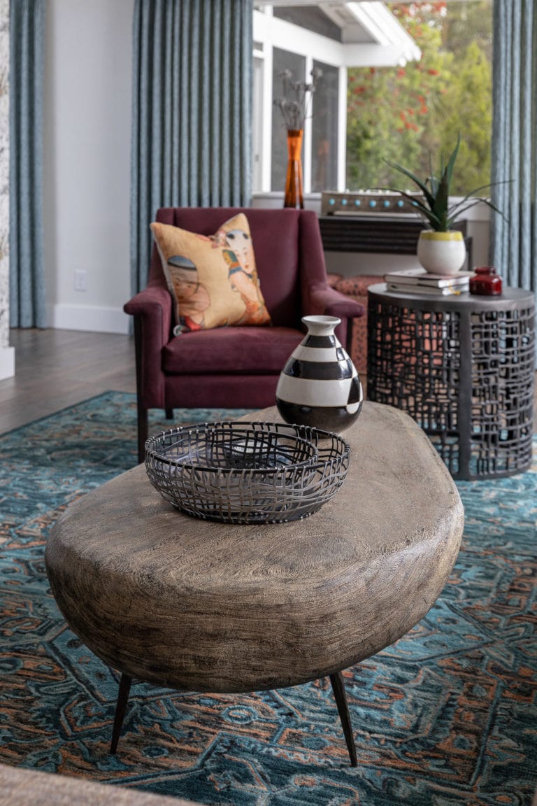 Mauve Armchair, Natural Coffee Table, Colorful area rug