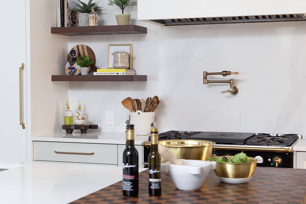 wooden countertop and floating shelves with pot filler